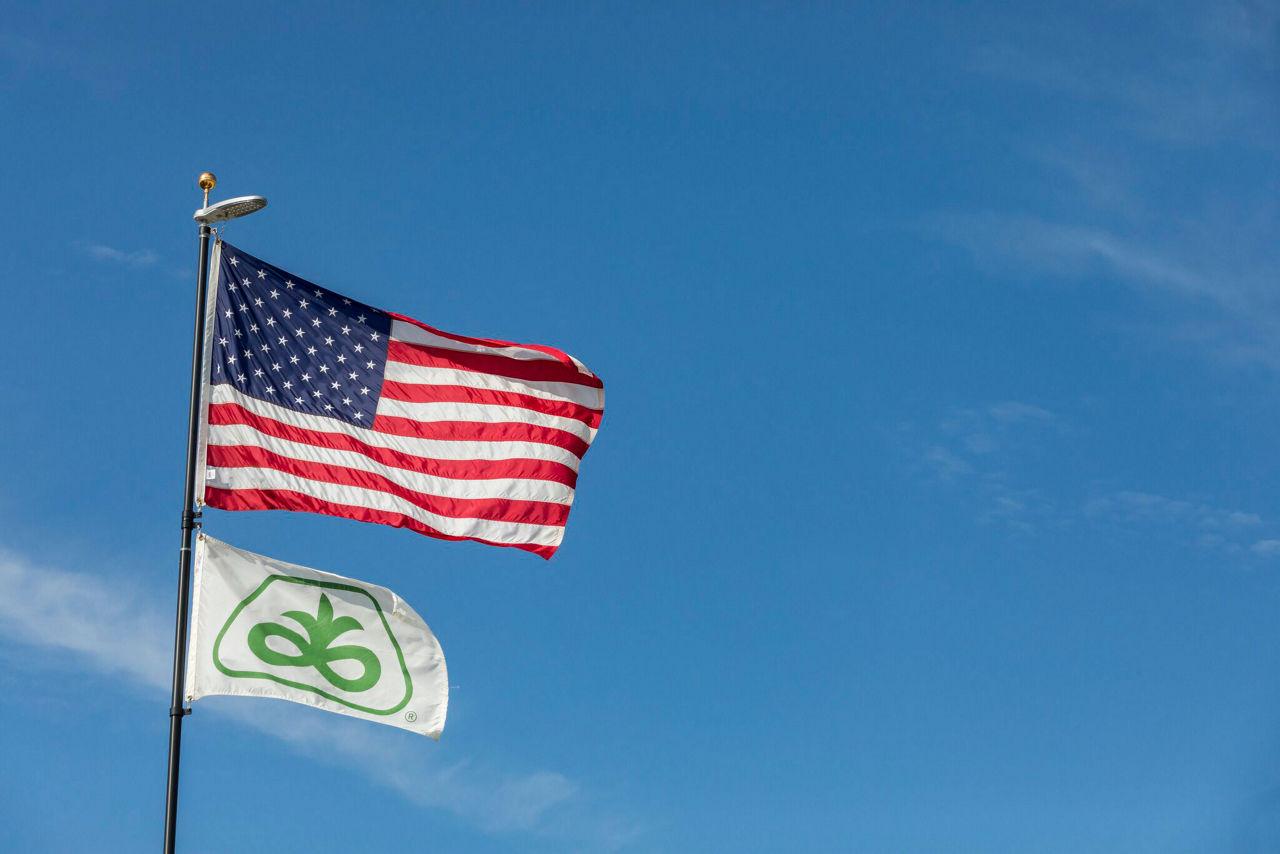 Pioneer and US flags on flagpole