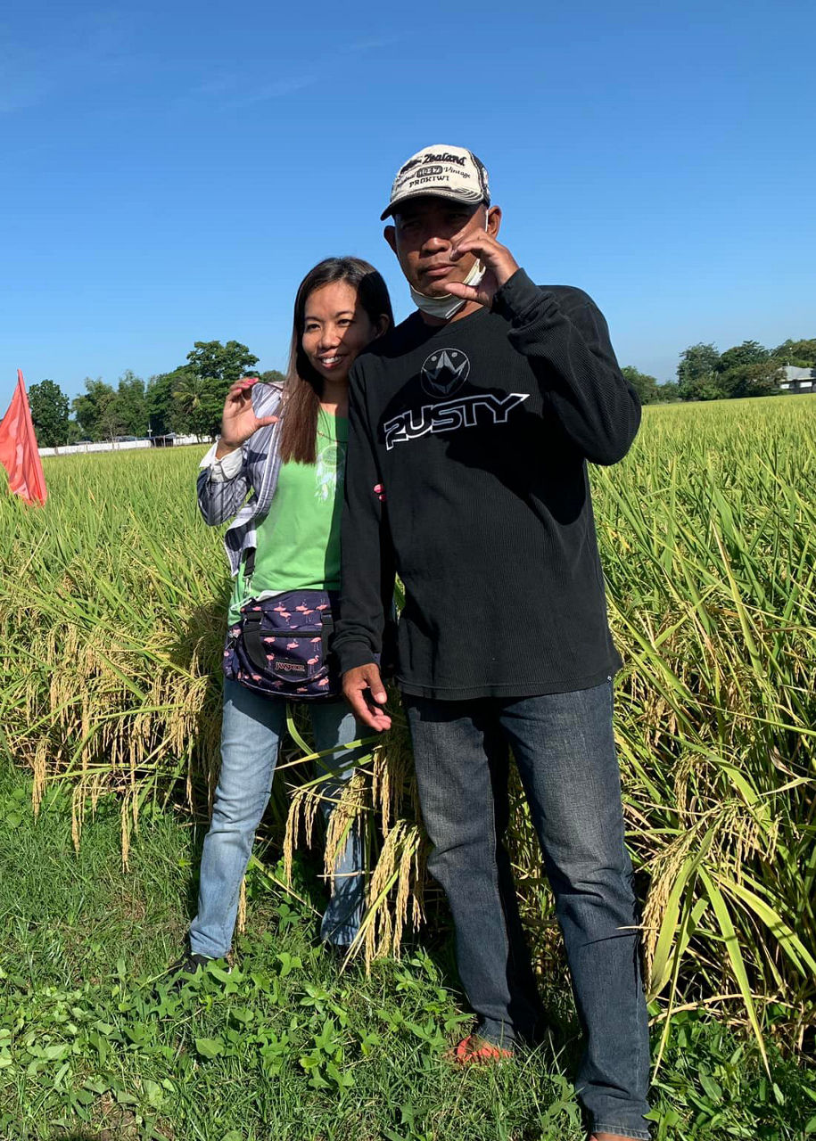 husband and wife doing the Corteva "C" hand sign