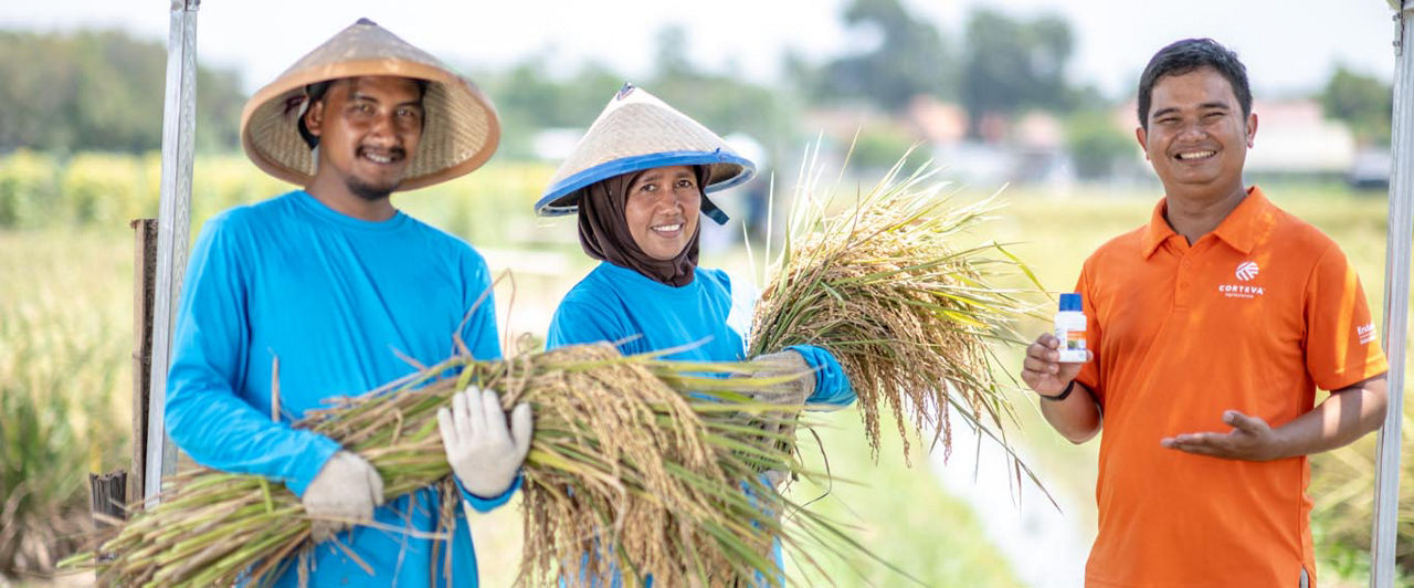Two farmers holding lettuce